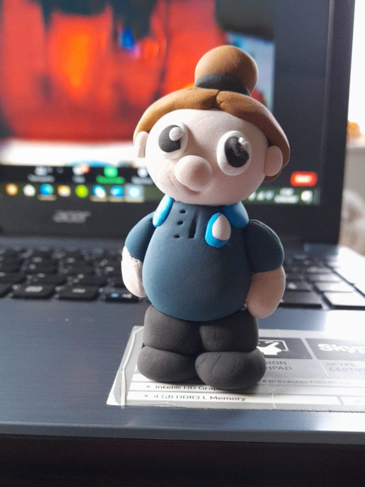 A leader mini me, in navy uniform with light brown hair.