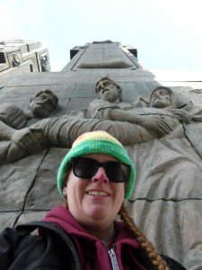 A selfie taken from a low angle so that the Chronicle pillars tower above me, almost blocking out the sky.