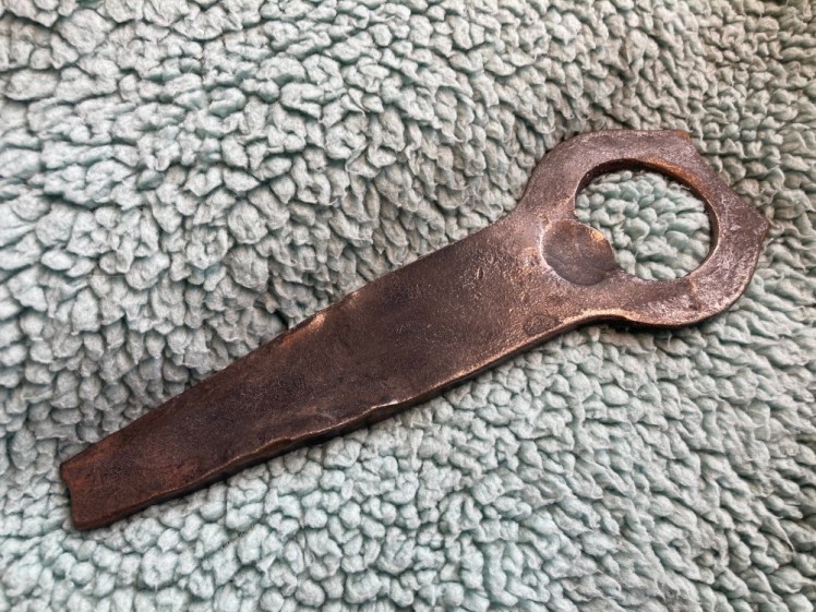 The complete bottle opener, a chunky piece of steel with a narrowed handle and a nice round head.