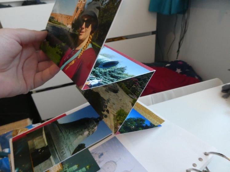 A concertina of photos. You can't see the velcro tab at the top. It's really just another hinged photo but with eight photos stuck back to back folding open.