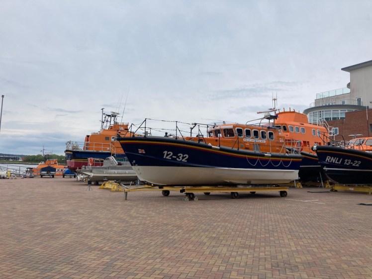 An assortment of lifeboats outside, including Shannon-class 13-22, a smallish Mersey-class and a couple of large Severn-classes.