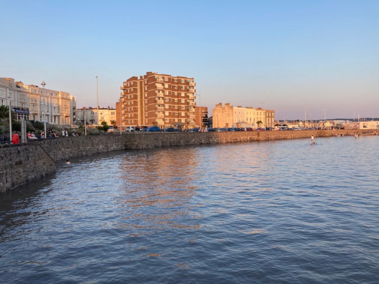 Weston Marine Lake in the early evening with water completely submerging the walkway and going partway up the wall.