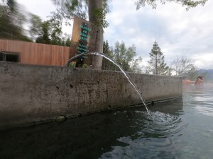 A jet of fresh drinking water squirting directly in a nice arc into the lagoon water.