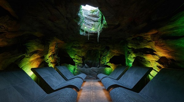 The Forest Cavern, a room which looks like six stone heated reclining benches have been dropped into a cave, complete with very realistic plant-draped hole in the ceiling.