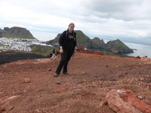 Awkwardly-posed selfie on the summit of Eldfell with Heimaey town and harbour in the background