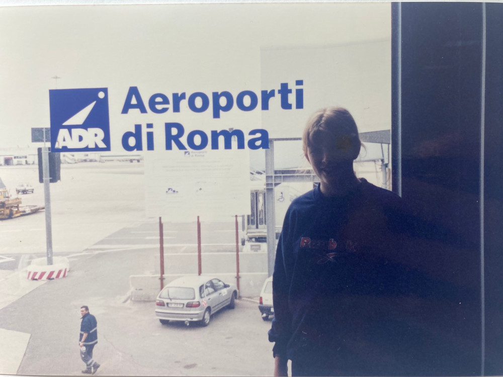 A picture of me, very badly silhouetted against the window of Rome Airport, with its logo and name in big blue letters.