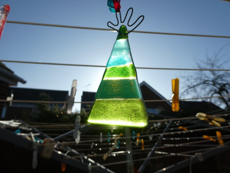 Stripy glass fused Christmas tree in the sunlight