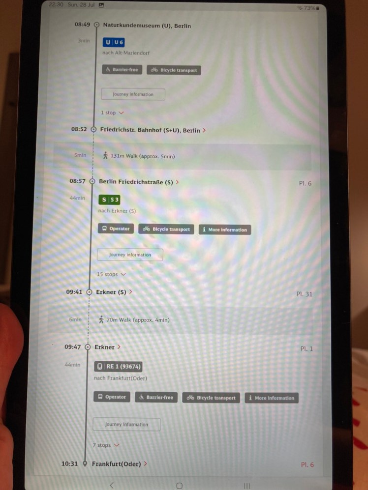 Me holding up my tablet, which is displaying my route from the hotel to Frankfurt am Oder, with all the distortion when one takes a photo of a screen. This was for practical reasons, so I could refer back to it along the way using my phone.