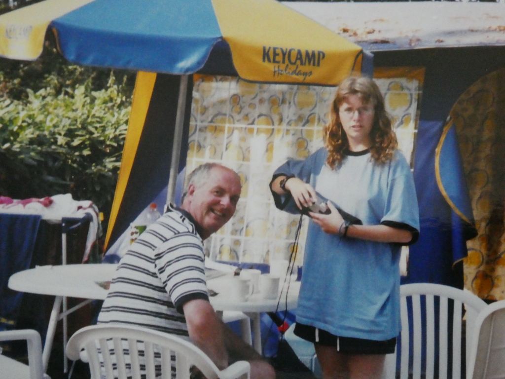 Me and my dad outside the Keycamp tent in around 2000. I'm wearing a very big blue t-shirt and looking disgruntled. He's sitting at the table looking over his shoulder and pretty pleased about something
