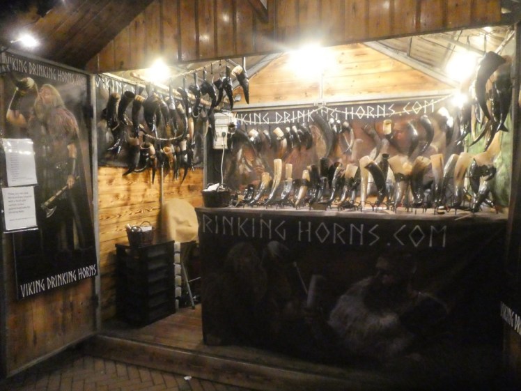 A stall of Viking drinking horns - polished cow horns with leather jackets standing on up little stands.