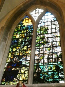 Oxford Christ Church Cathedral painted glass Jonah window. Jonah in the bottom corner is stained glass but the orange tree and the city are small panels of painted glass.