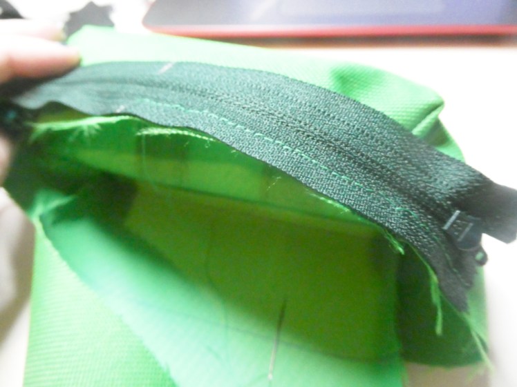 Zip sewn good side to good side from the centre outwards in one direction. In a moment, I'll do the same from the centre to the other end.