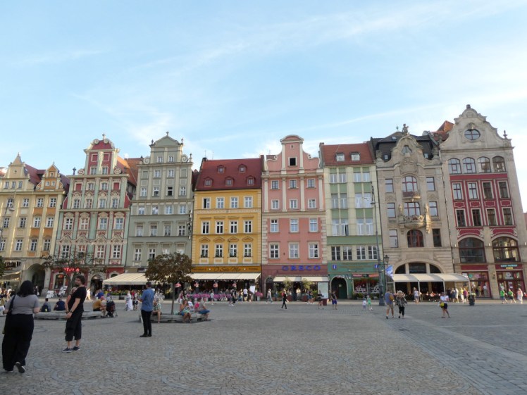 Colourful houses along the side of Wroclaw's old market square. There are a lot of people milling around in the square, far more than in Poznan.