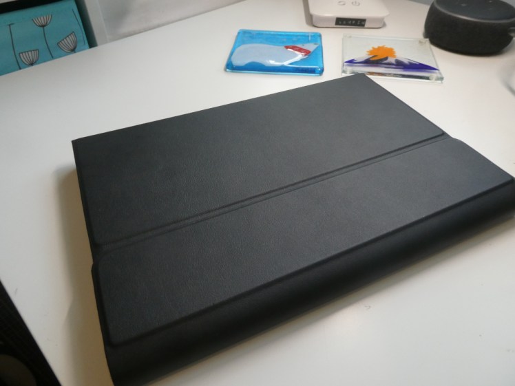 My tablet, lying on my desk, in its case. The case is leather-effect, folded over to enclose tablet, removal magnetic keyboard and S-pen.