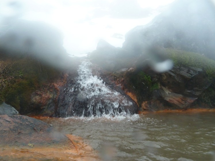 Boiling water pouring into the spring, like a little waterfall. My camera's waterproof case is badly misted up by now but you can make out the steam coming off the water.