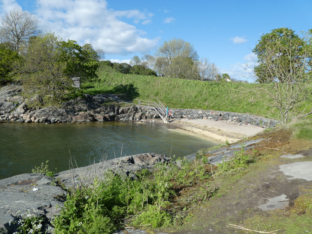 A small cove on Suomenlinna where it's sheltered enough to swim. There's a half-circle of yellow beach at one end and relatively high steep sides of rock protecting it from the wind. Sitting here, if I look to the left instead of the right, I can see across to Helsinki but I haven't included that photo because it's straight into the lowish evening sun and thus silhouetted.