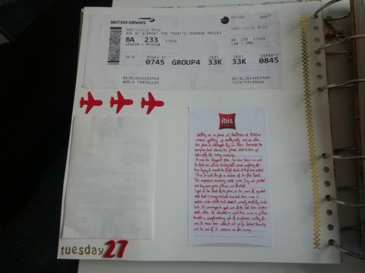 The first page of my Russia scrapbook, featuring my boarding pass (with important bits blurred out), my folded Aeroexpress ticket and a bit of journalling in red pen.