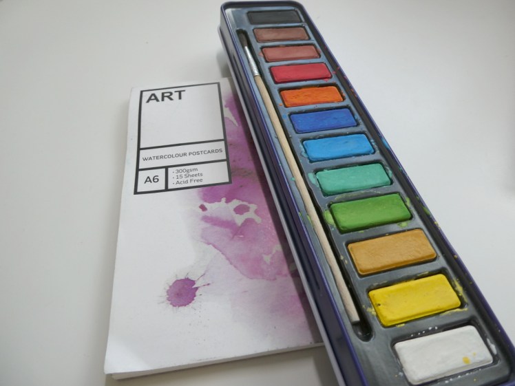 An A6 pad of watercolour postcards - just watercolour paper cut small - and a long thin tin of
