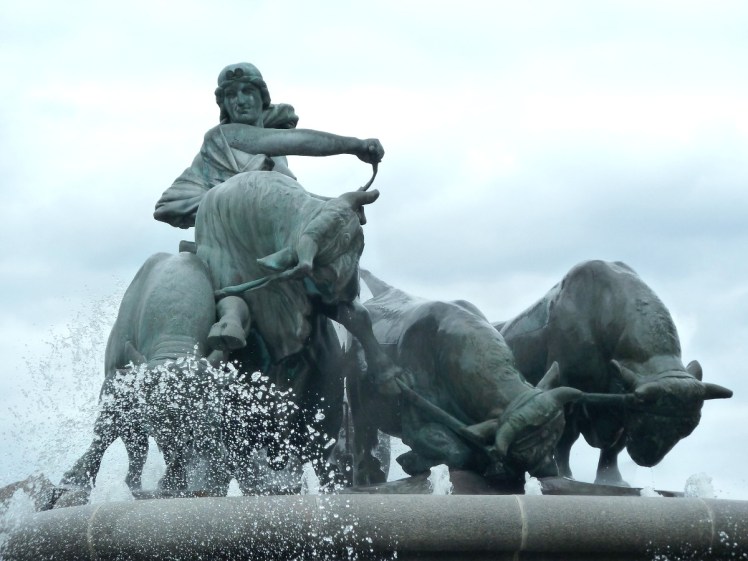 Green bronze fountain of Gefion, a Norse goddess, riding four oxen as she carves up the island that Copenhagen will be built on.