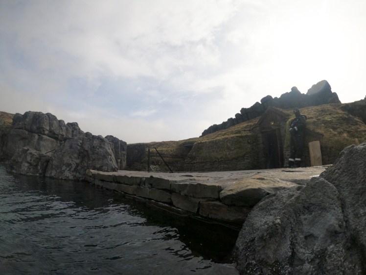 The little hut where the Ritual takes place, a door into the cliffs. In the pavement in front is a round sunken cold pool that you can't really see from this angle.