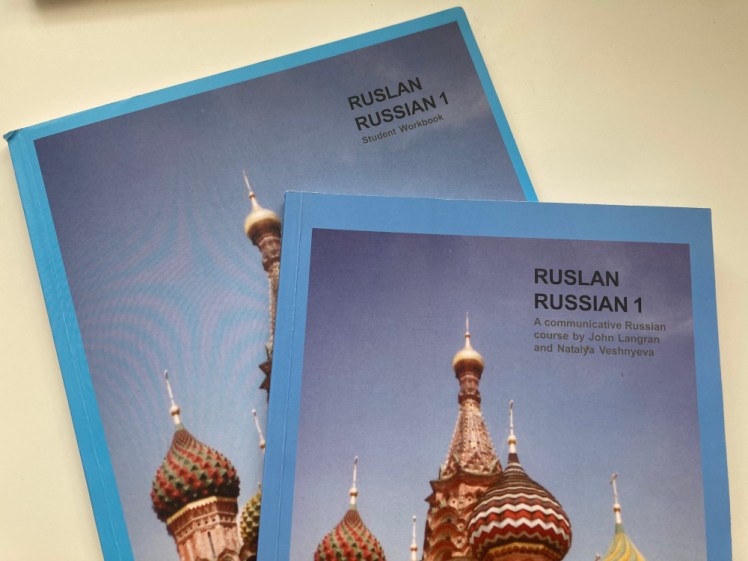 Ruslan Russian 1 course book and workbook. They're both blue books with a picture of St Basil's Cathedral on the front. The difference between the two is in the small text below the title.