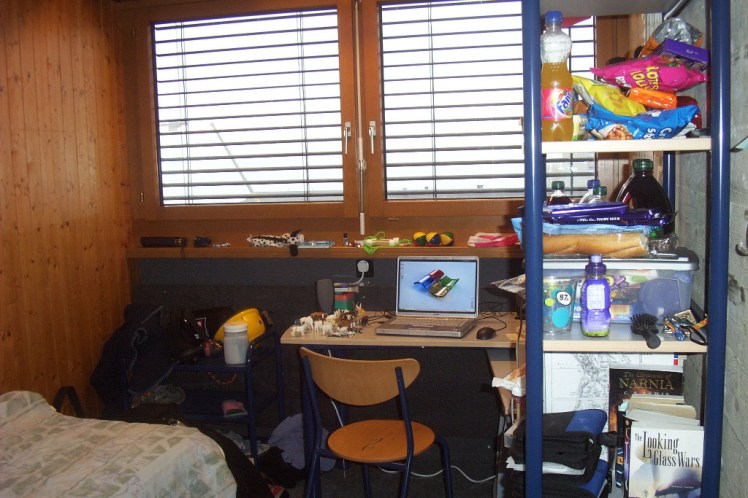My student room in Switzerland. One wooden wall, one concrete wall, one brick wall not shown. So much clutter!