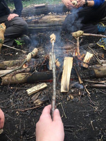 Cooking the damper over the fire