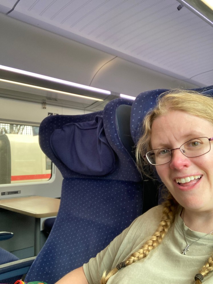 A grinning selfie sitting in my nice comfy train seat on my way to Berlin.
