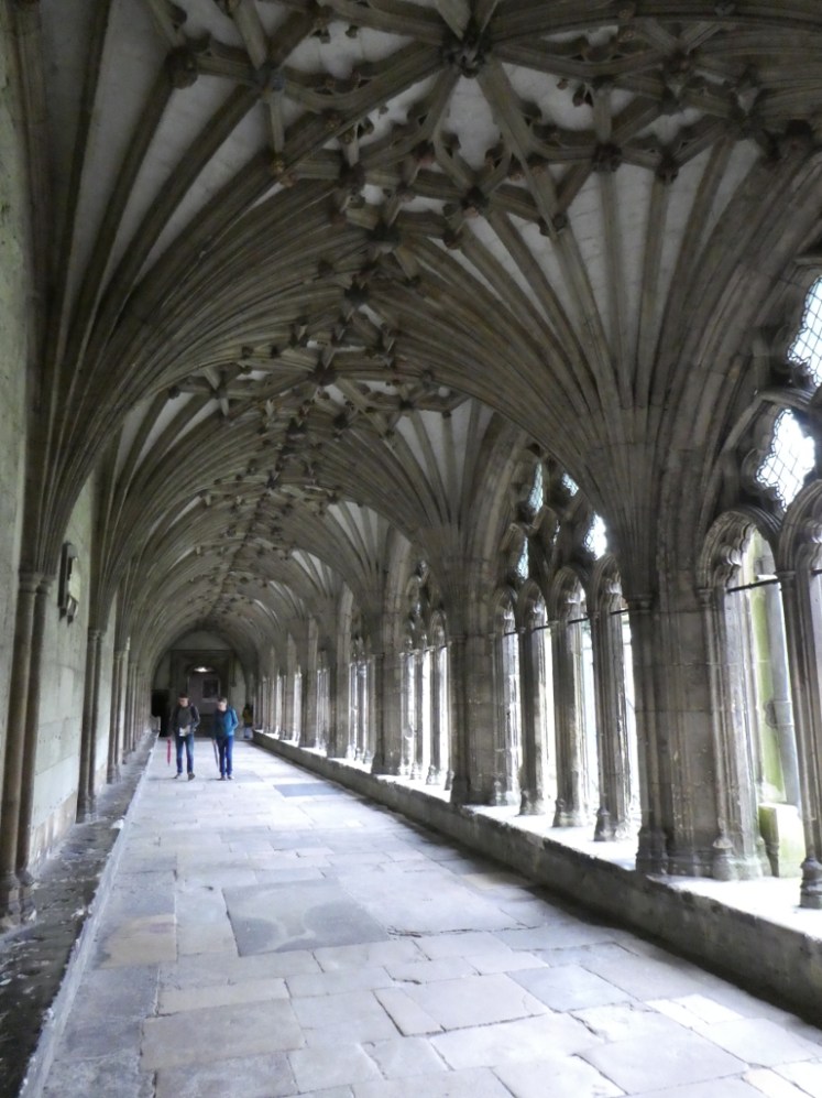 A priest chatting in the Gothic cloisters