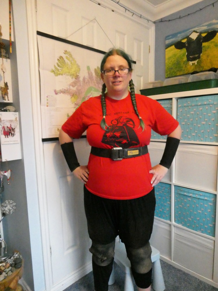 Me in a red caving t-shirt wearing my neoprene cuffs, my belt and my knee pads. I sort of look like a superhero but I also sort of look like an idiot.