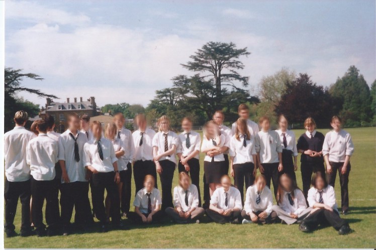 Last day of year 11 on the main field at my school. There's a manor house just visible behind my science group. I'm wearing a navy jumper. Everyone else is in shirts.