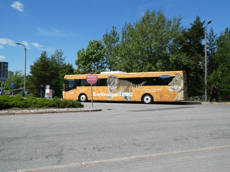 The Korkeasaari bus from central Helsinki. It's a single-decker, yellow and has a lion and tiger on the side.