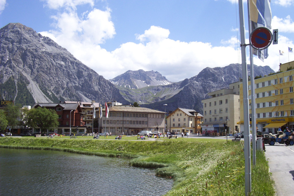 Some of the bigger buildings in Arosa, set between the lake and the craggy mountains.