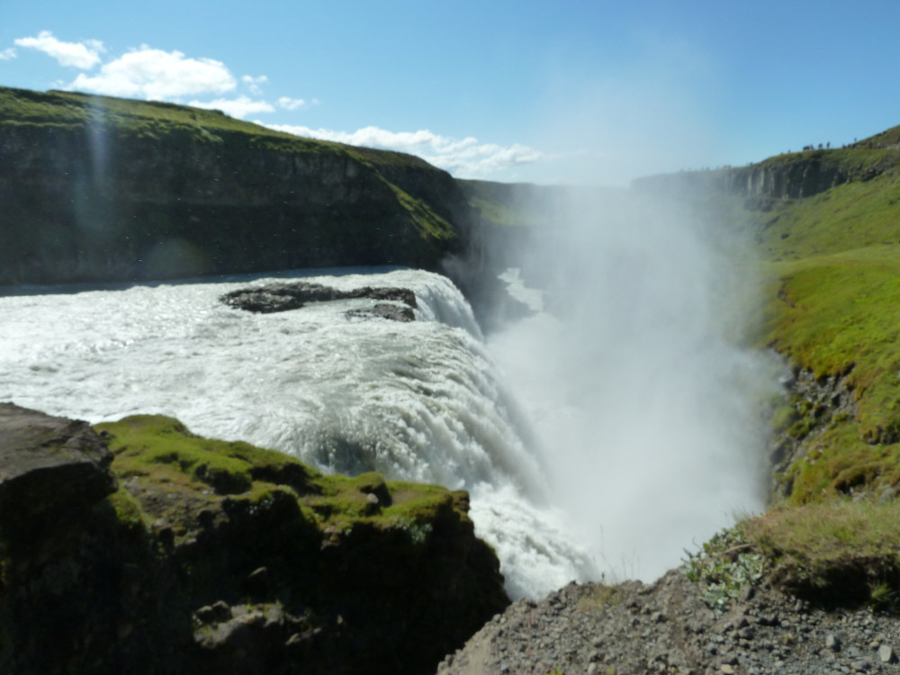 Gullfoss, a huge waterfall that manages to fall sideways into a narrow canyon. You can't see the bottom because of the amount of spray coming up.