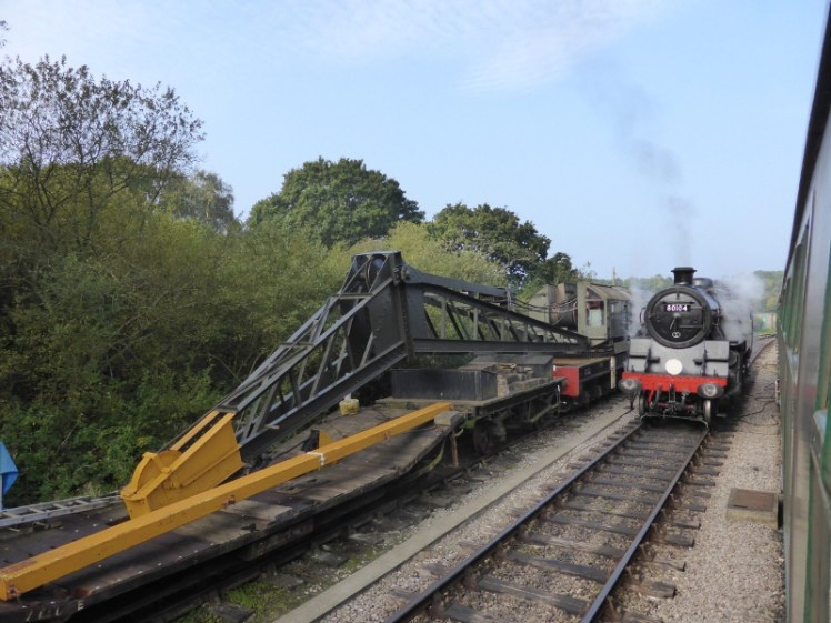 Steam train passing along the Swanage Railway