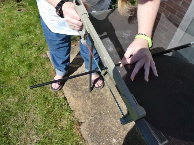Cutting the new pole with an oversized hacksaw