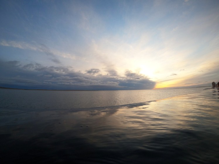 Clouds covering the sun shortly before sunset as seen from the lagoon's infinity edge.