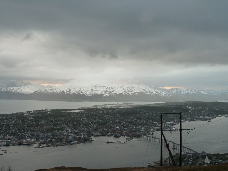 Another try at the Midnight Sun, this time from on top of a mountain. It's gloomy and cloudy and there's barely a hint of a glow this time.