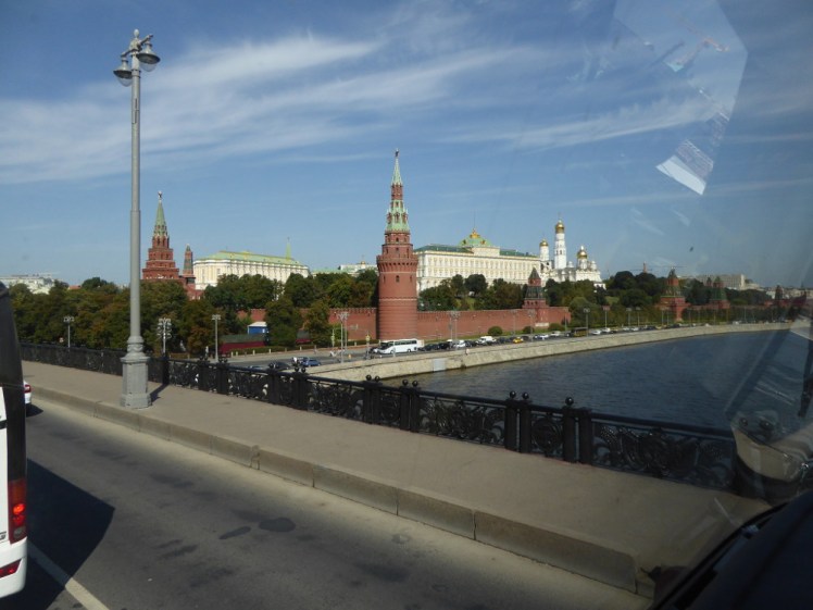 The Kremlin walls, some towers and the administrative and religious buildings peeking over the top, as seen from a road crossing the river that flows alongside the walls. You can tell I'm on a bus partly because you can just make out traffic around the edge of the photo but mostly because there's an obvious reflection in the windows visible to the right.
