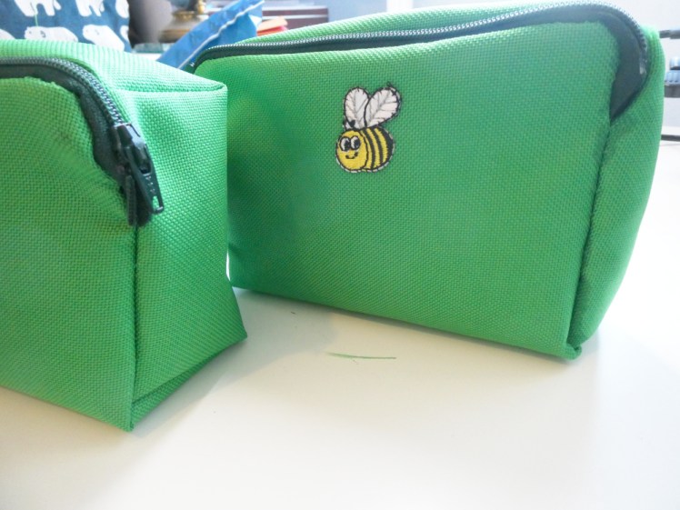 My two complete pockets showing how I did the zips. On the left is the second one. The seams are neater but the ends of the zip are sticking out. On the right, the zip is set properly inside the seam but the seams are messier and stained with Mod Podge.