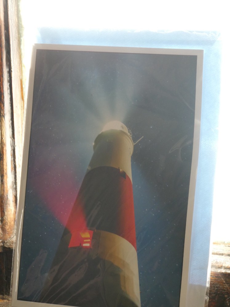 The lighthouse with its main light and sector light both lit