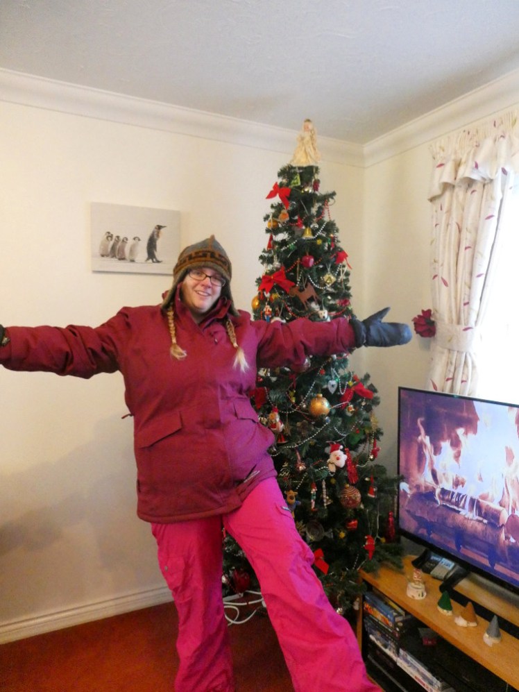 Me in my luminous pink ski trousers. I'm standing on one leg with the other held out for a better view from the camera, with my arms spread and wearing my ski jacket and hat. We'll get to them later.