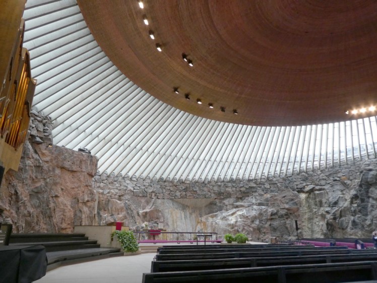 On the floor of the church, looking up at the dome with the rock walls taking pride of place.