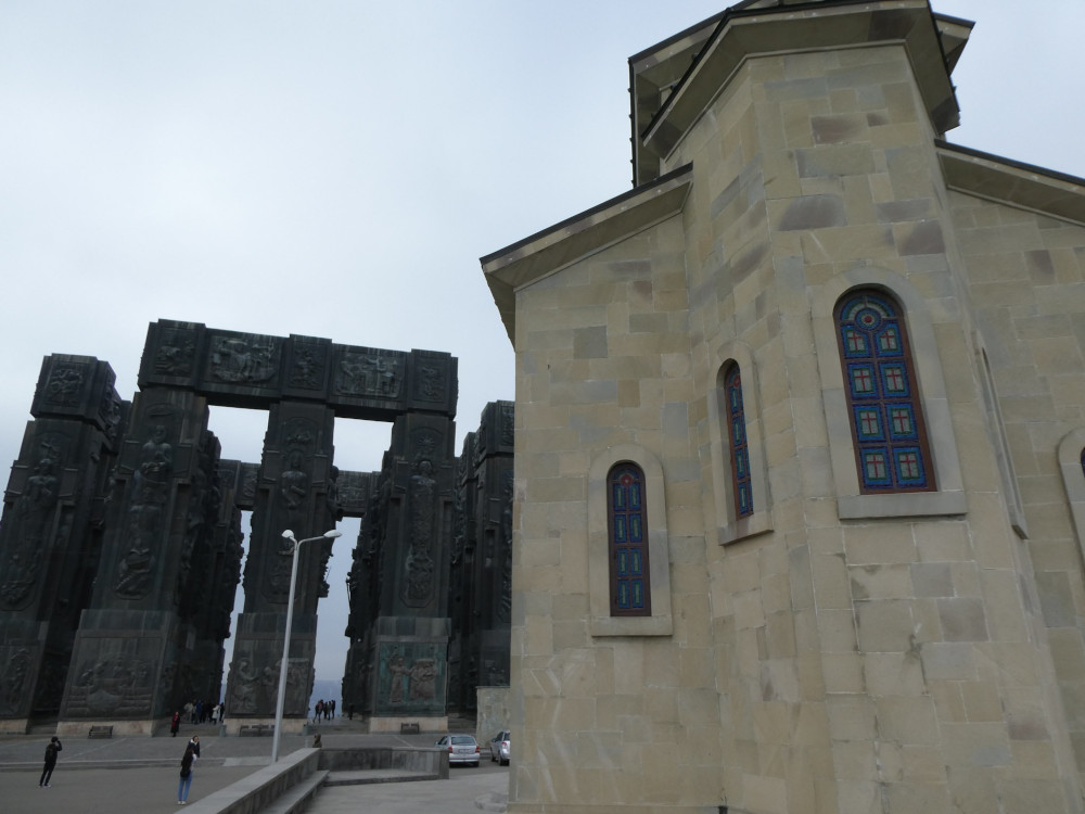 The Chronicle of Georgia in the background with a Georgian-style church in the foreground.