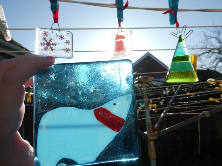 Fused glass Christmas decorations in the sun
