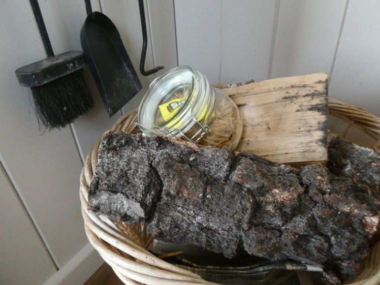 Basket of logs with a jar of firelighters and matches