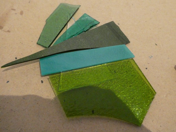 Green glass ready to be cut to make a tree