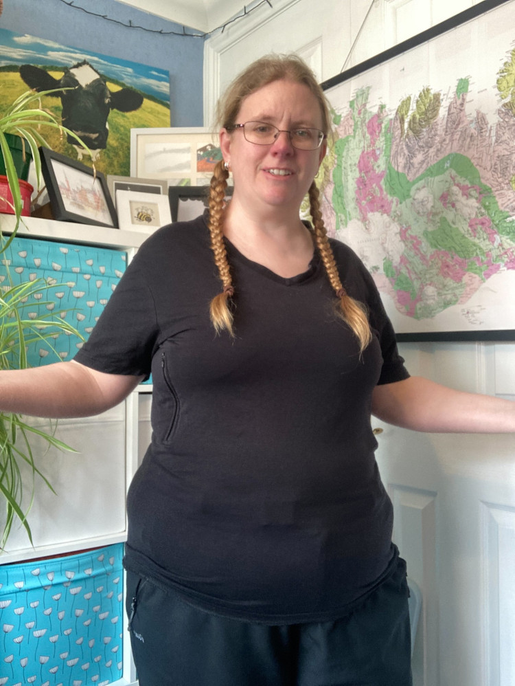 Me in my office wearing the black v-neck t-shirt with the hidden pockets that I often wear to travel in.