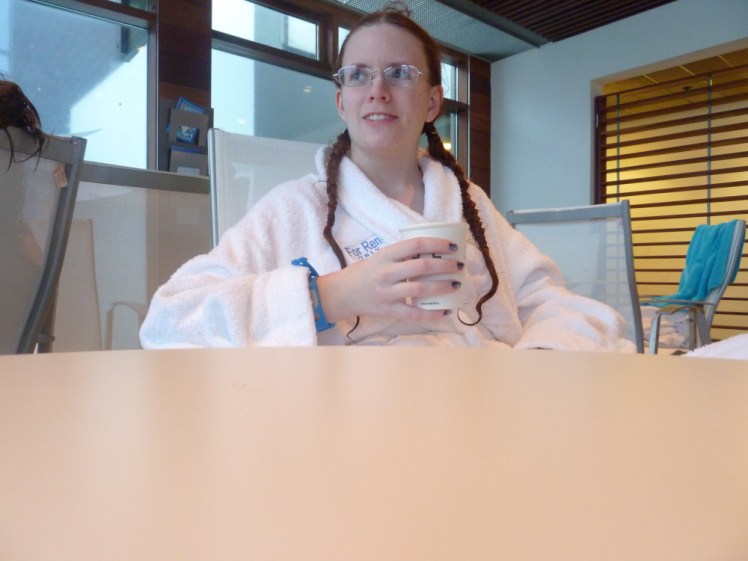 Me relaxing in a white spa robe with a cup of hot chocolate at the Blue Lagoon in the winter of 2011.