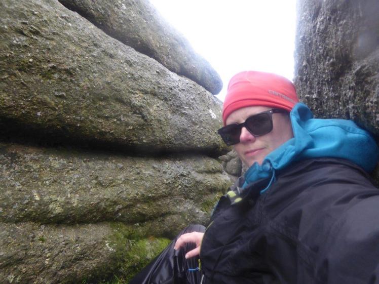 Selfie taken while sheltering from rain and howling wind between two crags on top of Haytor Rocks.